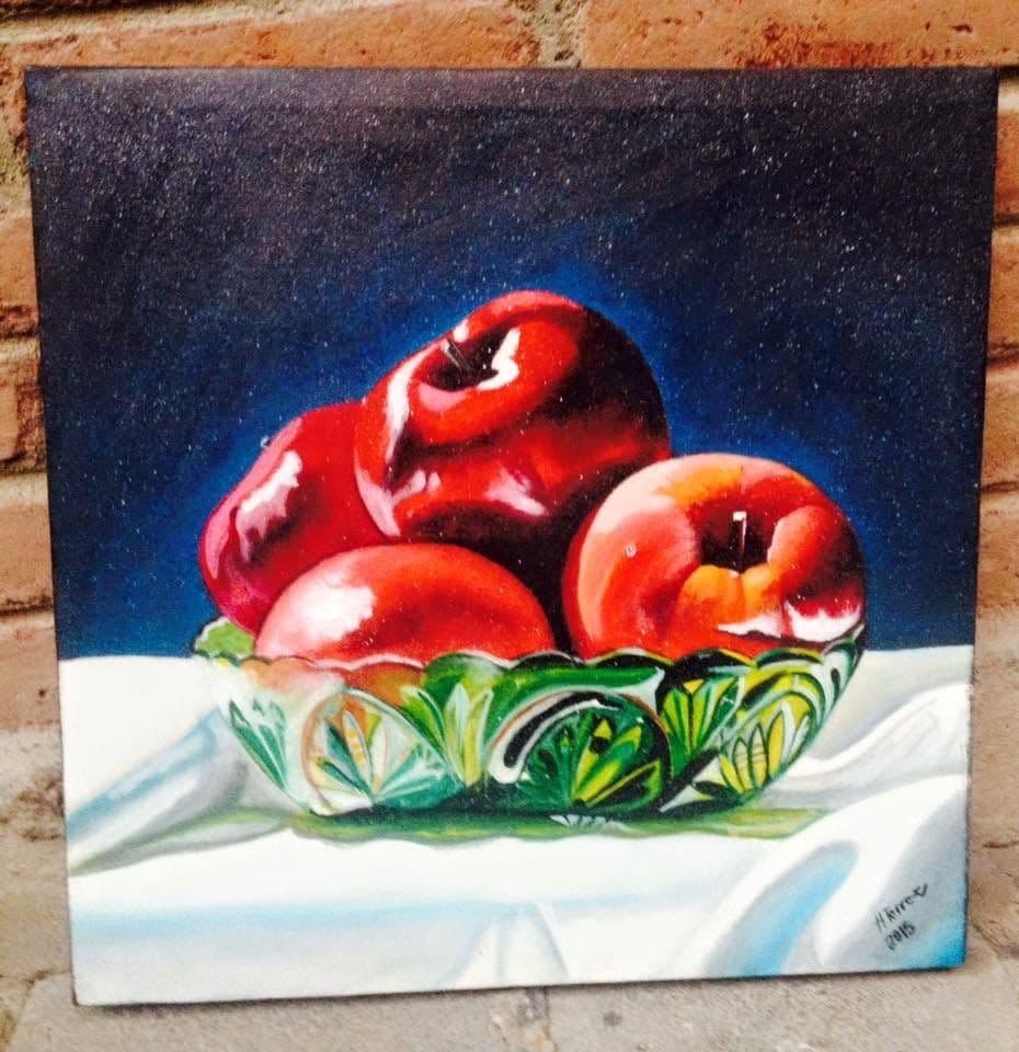 A still life of apples in a glass bowl, painted on canvas.