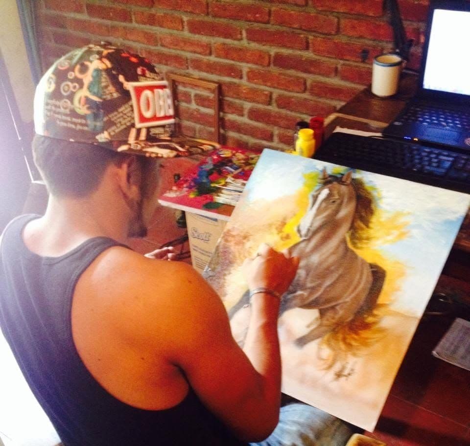 Alvir painting a horse during his early practice in Nicaragua.