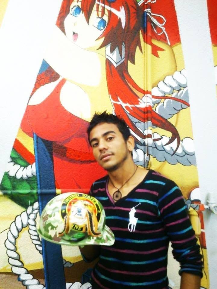 Alvir holding a hand-painted helmet.