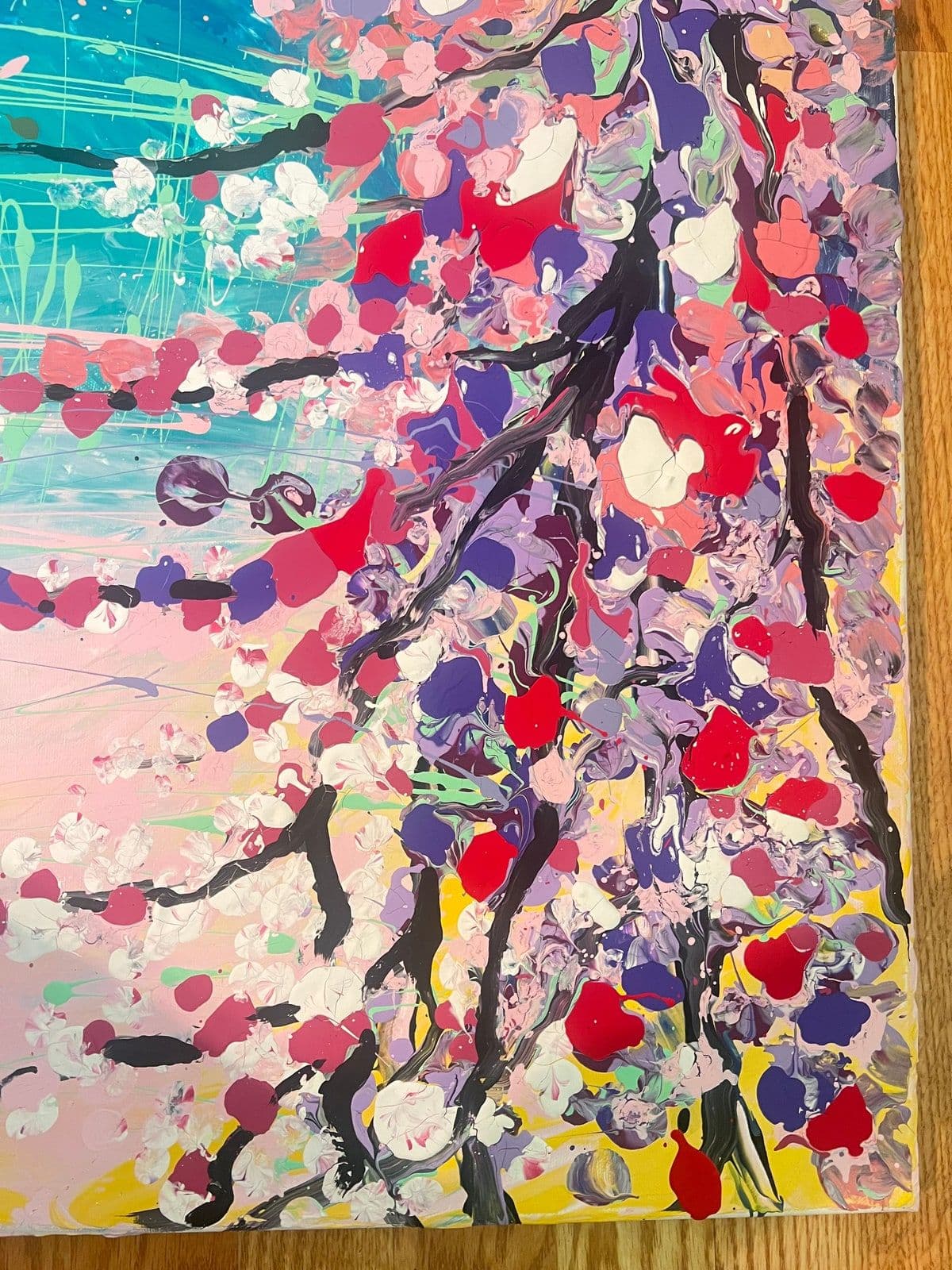 An abstract painting built from layers of colour and spattered paint.