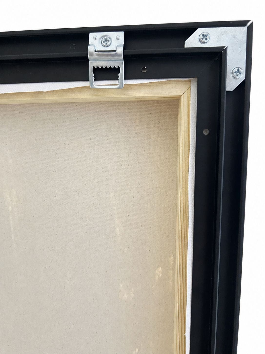 The hanging hardware and a metal corner bracket screwed into the frame at the back