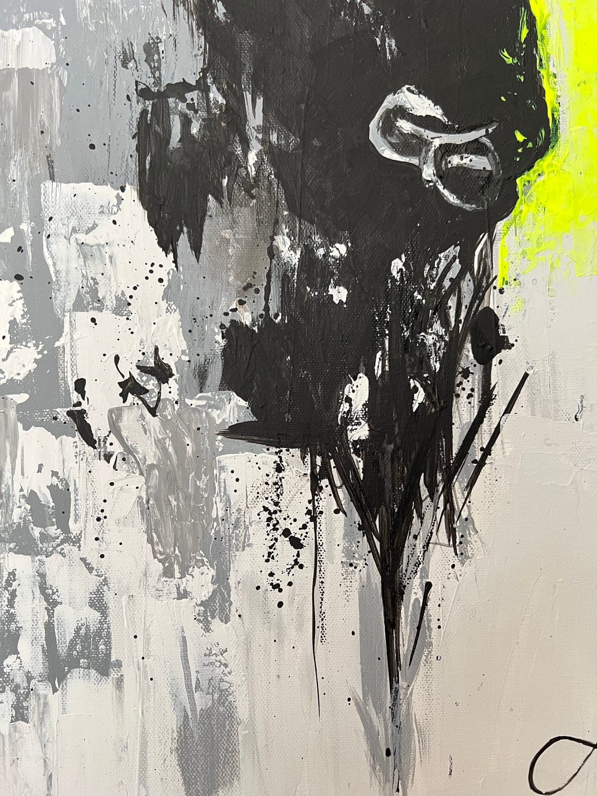 The silver nose ring in close-up, raised out of the wet black paint
