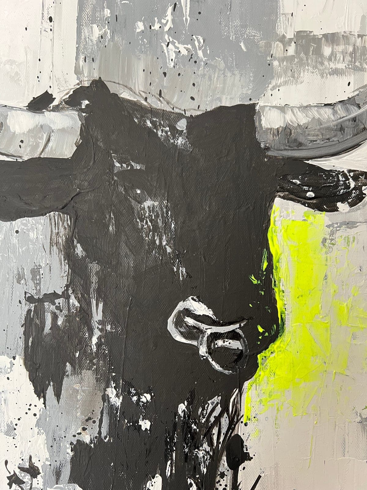 The fluorescent yellow laid thick over the black of the head, the silver ring below