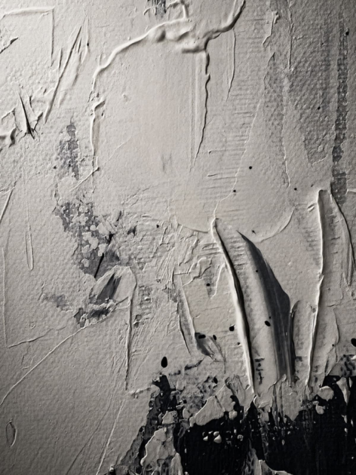 White impasto raked into ridges, the black underpainting showing at the edge